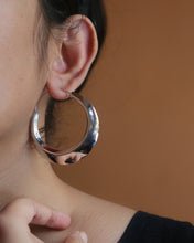 Silver hoop earrings with a slant