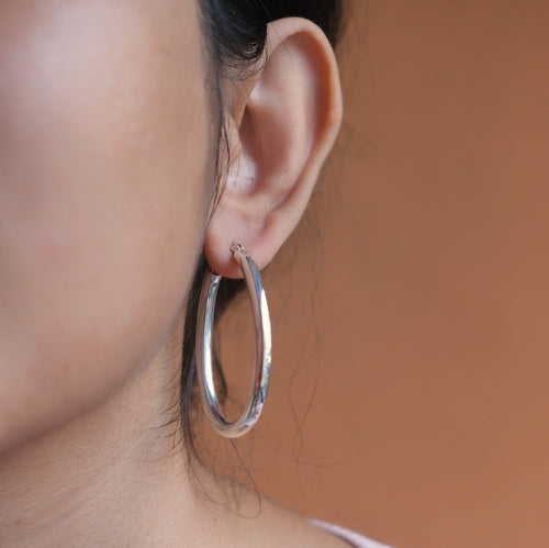 Oval pipe shaped hoop earrings