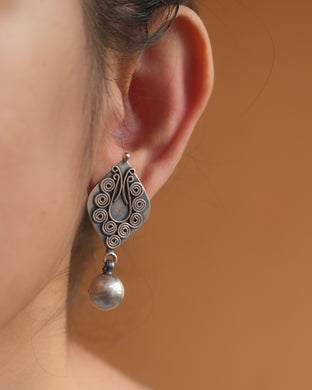 Silver earring with dangling bead