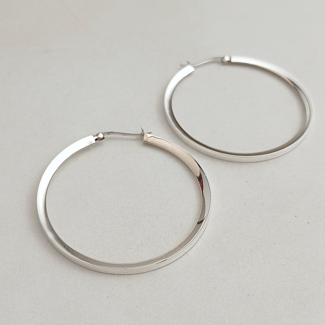 Flat inward slant silver hoop earrings