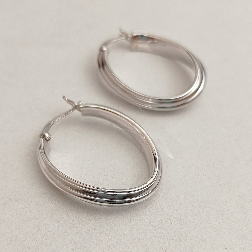 Twisted oval  silver hoop earrings
